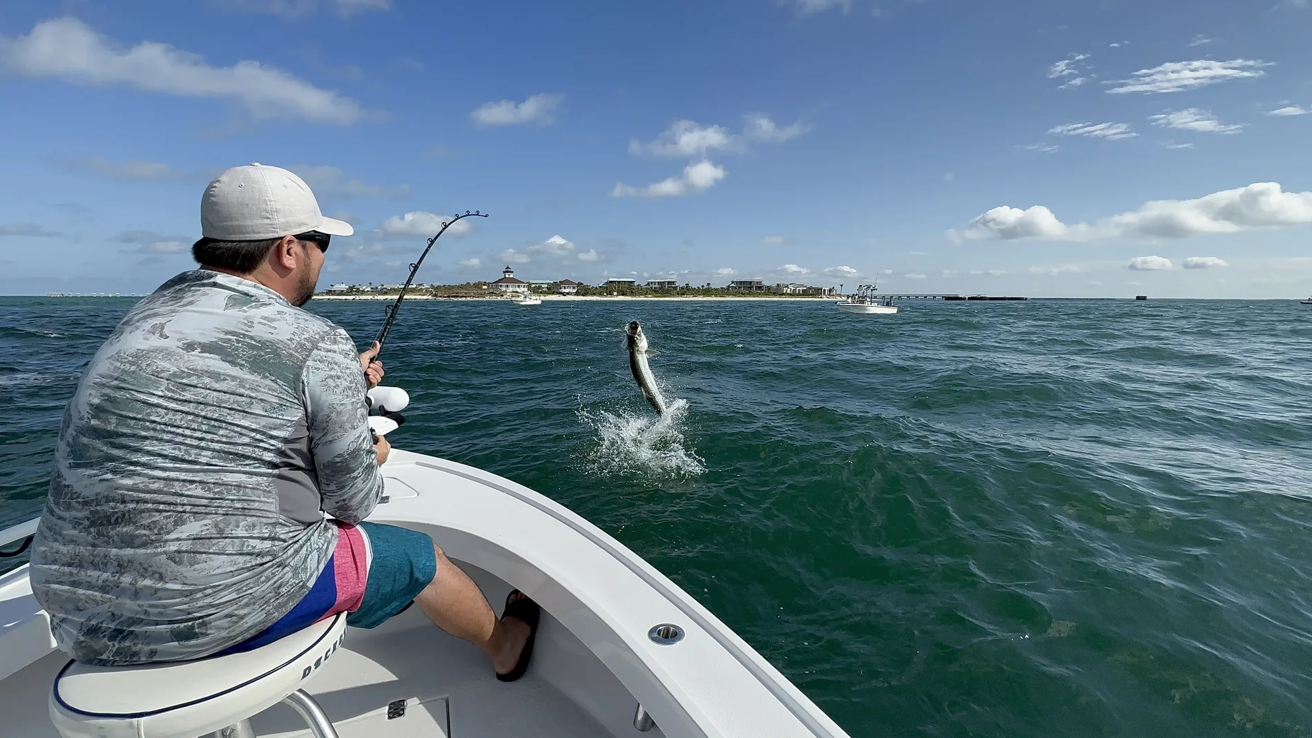 Angler holding a tarpon caught on a local charter